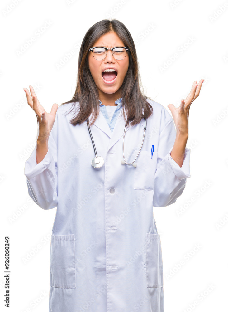 Young asian doctor woman over isolated background crazy and mad shouting and yelling with aggressive expression and arms raised. Frustration concept. Young asian doctor woman over isolated background crazy and mad shouting and yelling with aggressive expression and arms raised. Frustration concept.