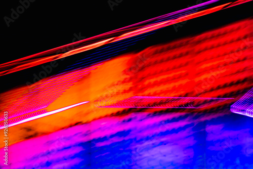 A colorful, abstract image with a red and blue line. The colors are bright and vibrant, giving the image a lively and energetic feel