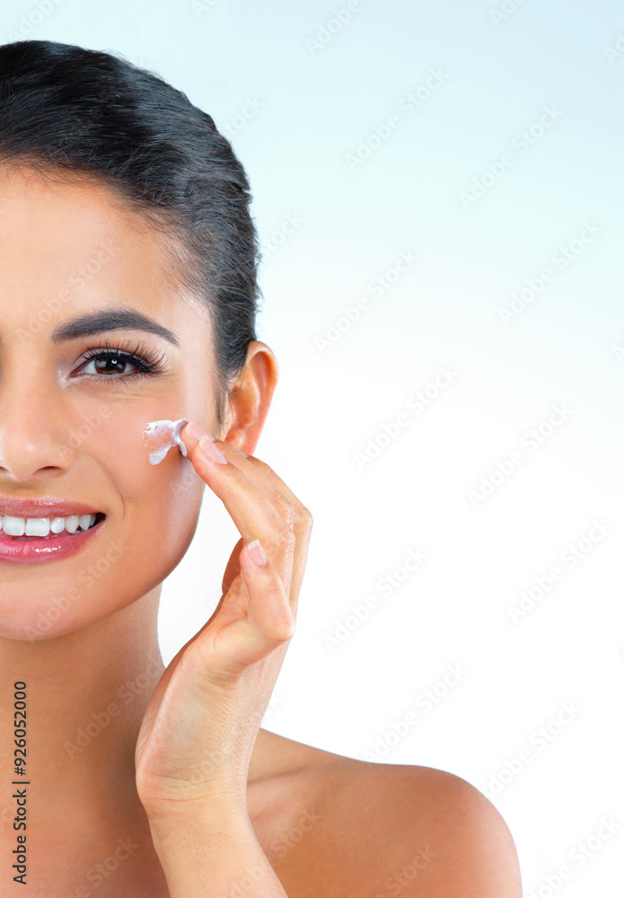 Woman, beauty and portrait with cream in studio for wellness, glow and mock up space by blue background. Girl, model and person with cosmetics, moisturizer and dermatology with skincare in Mexico Woman, beauty and portrait with cream in studio for wellness, glow and mock up space by blue background. Girl, model and person with cosmetics, moisturizer and dermatology with skincare in Mexico