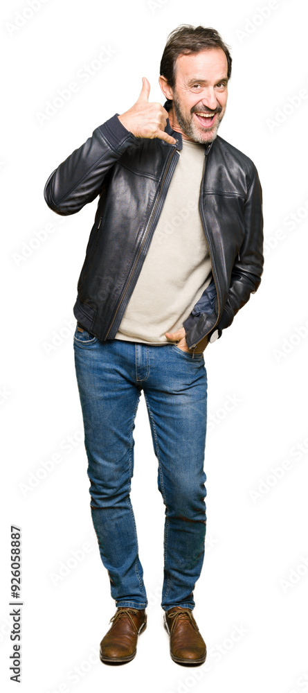 Middle age handsome man wearing black leather jacket smiling doing phone gesture with hand and fingers like talking on the telephone. Communicating concepts. Middle age handsome man wearing black leather jacket smiling doing phone gesture with hand and fingers like talking on the telephone. Communicating concepts.
