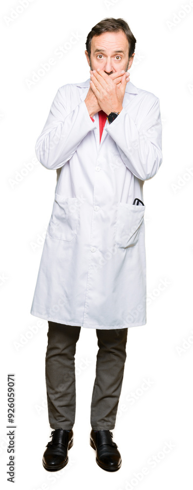 Middle age therapist wearing white coat shocked covering mouth with hands for mistake. Secret concept. Middle age therapist wearing white coat shocked covering mouth with hands for mistake. Secret concept.