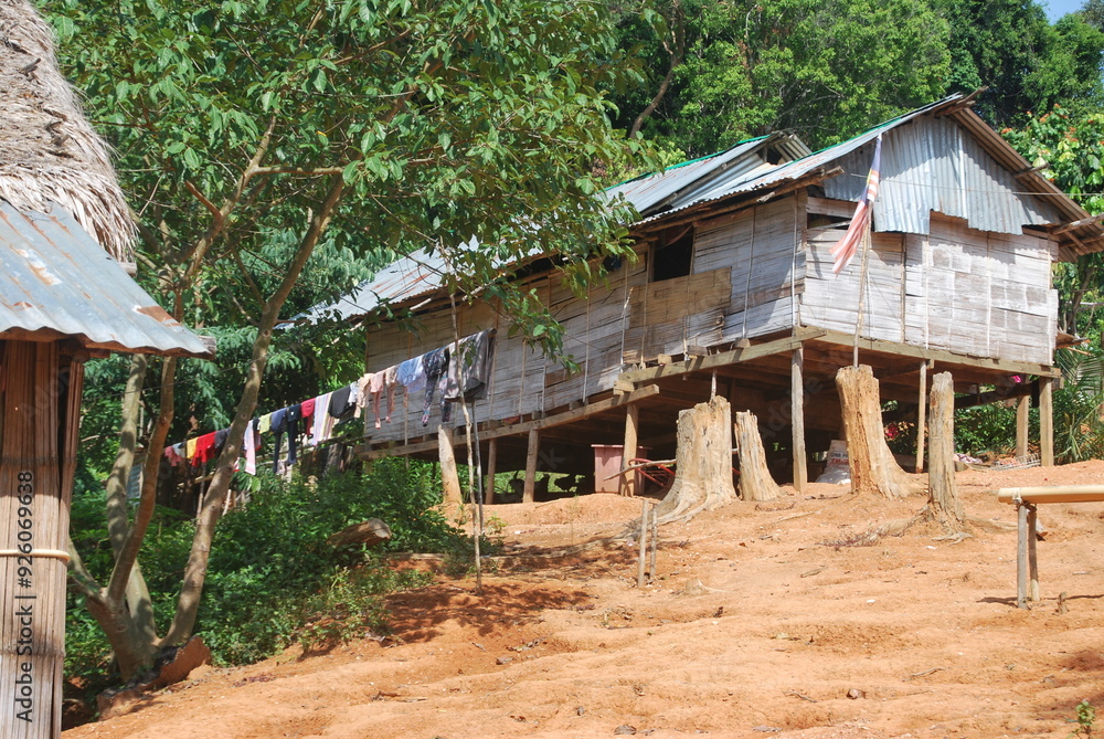 Traditional Asli village with rustic wooden huts surrounded by lush greenery, showcasing the indigenous culture and lifestyle of Malaysia's native people. Perfect for cultural, anthropological, and tr Traditional Asli village with rustic wooden huts surrounded by lush greenery, showcasing the indigenous culture and lifestyle of Malaysia's native people. Perfect for cultural, anthropological, and tr