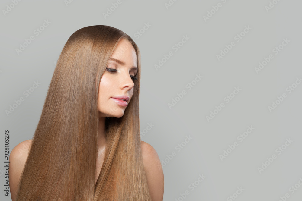Stylish young woman model with modern make-up and long straight smooth hairstyle standing on white studio background Stylish young woman model with modern make-up and long straight smooth hairstyle standing on white studio background