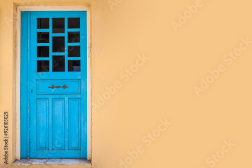 Yellow wall background with blue retro door