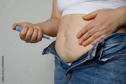 Woman taking an insulin or semaglutide shot at home