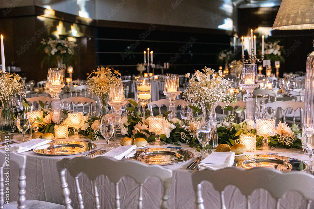 Elegant Wedding Table Setting with Candles and Floral Centerpieces