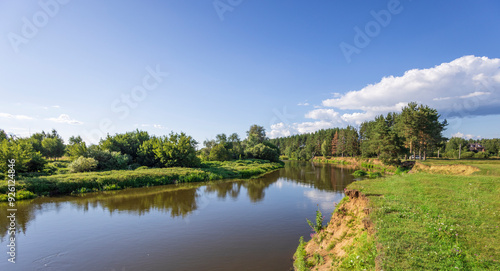 A river with a green forest on the left bank