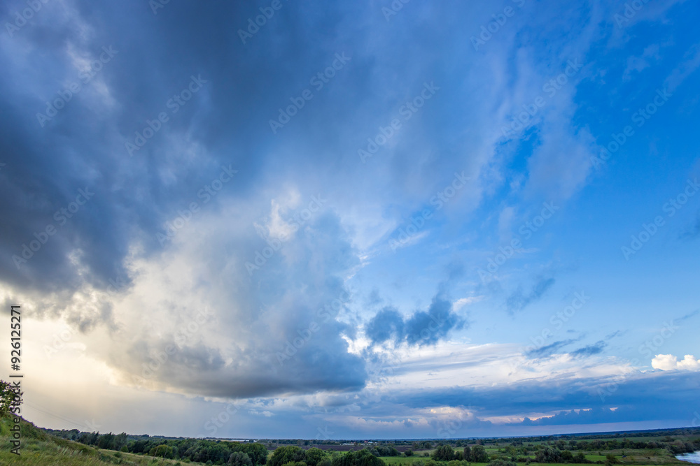 A breathtaking view unfolds with dark clouds contrasting against a vibrant sky, as the sun sets over a peaceful countryside. A breathtaking view unfolds with dark clouds contrasting against a vibrant sky, as the sun sets over a peaceful countryside.