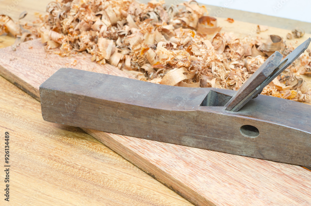 Shavings after planing of wood ash on the background of the plane close up.DIY concept. Woodworking and crafts tools. Carpentry hand tools. Wooden Shavings after planing of wood ash on the background of the plane close up.DIY concept. Woodworking and crafts tools. Carpentry hand tools. Wooden