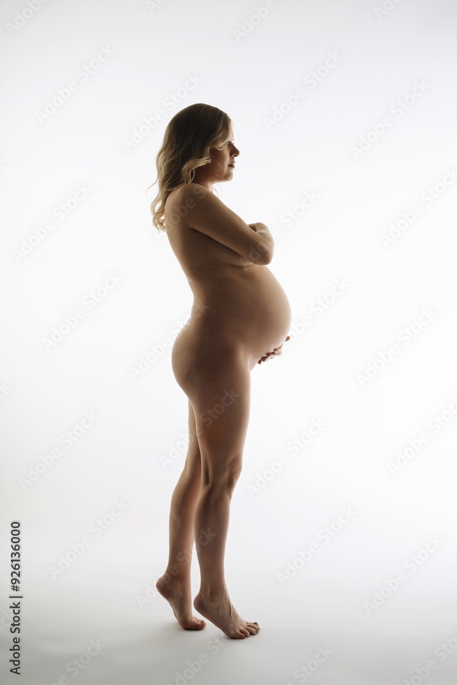 Fototapeta premium Pregnant Woman Standing in White Room