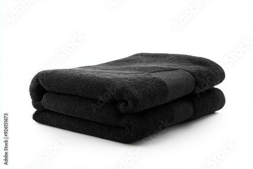A black towel neatly folded, isolated on a white background, emphasizing its soft texture and clean lines, perfect for bathroom or spa settings, selected focus

