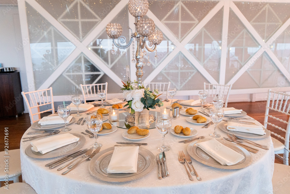 Elegant Wedding Venue with Floral Arrangements and Crystal Chairs