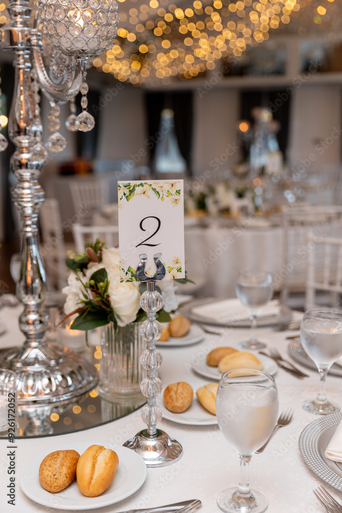 Elegant Wedding Venue with Floral Arrangements and Crystal Chairs