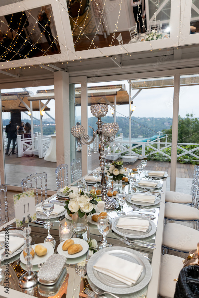Elegant Wedding Venue with Floral Arrangements and Crystal Chairs
