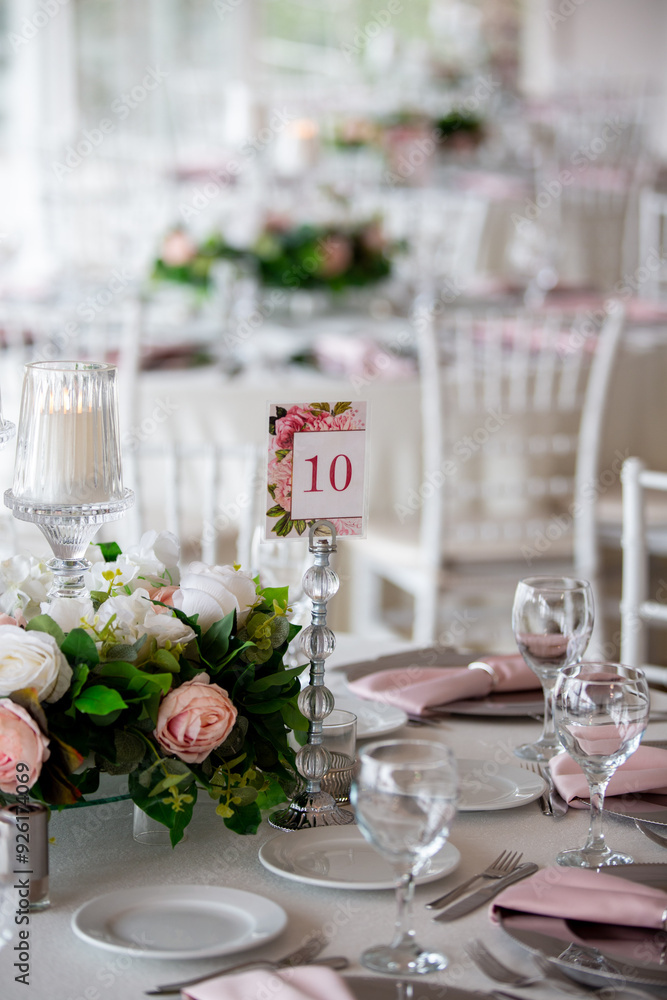 Elegant Wedding Venue with Floral Arrangements and Crystal Chairs