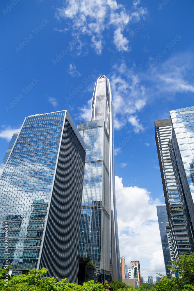View of multi-story high-rise buildings made of glass and metal View of multi-story high-rise buildings made of glass and metal