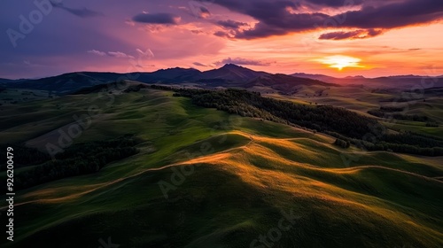  In Boulder, Colorado's hills, the sun sets amidst clouds as rolling terrain unfolds