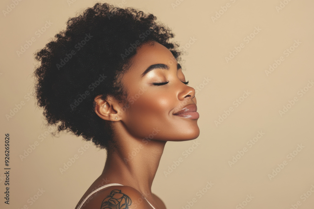 A close up of a tattooed black woman's face with her eyes closed A close up of a tattooed black woman's face with her eyes closed