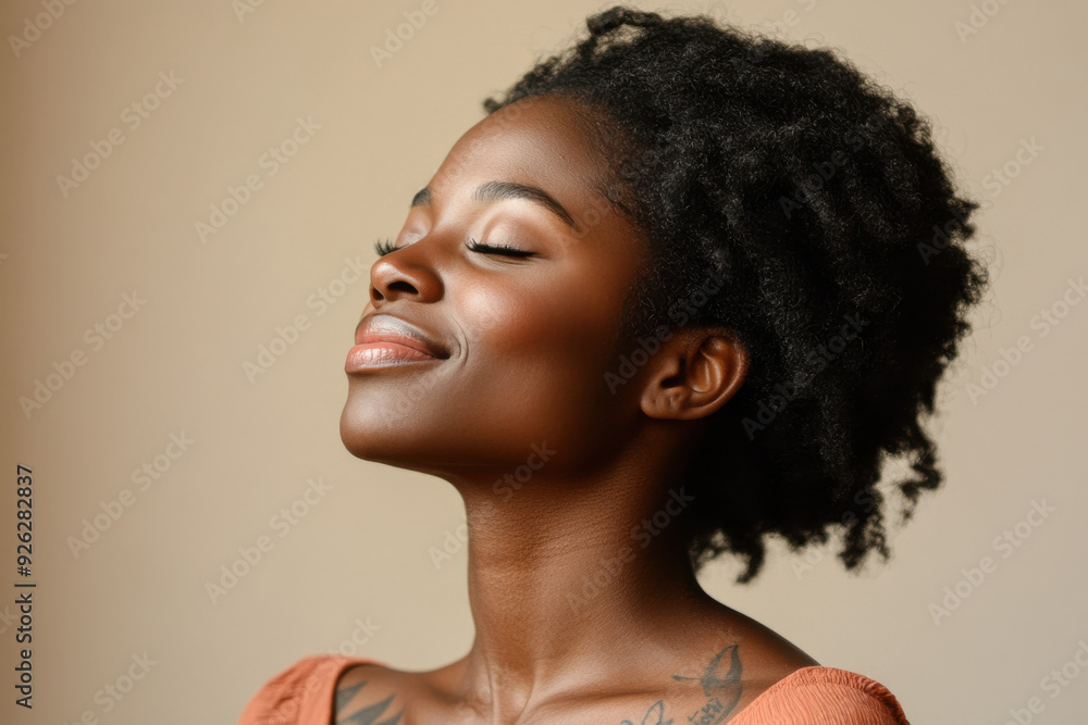 A close up of a tattooed black woman's face with her eyes closed A close up of a tattooed black woman's face with her eyes closed
