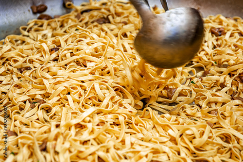 a delicious pot of tagliatelle with porcini mushrooms and sausage cooking photo