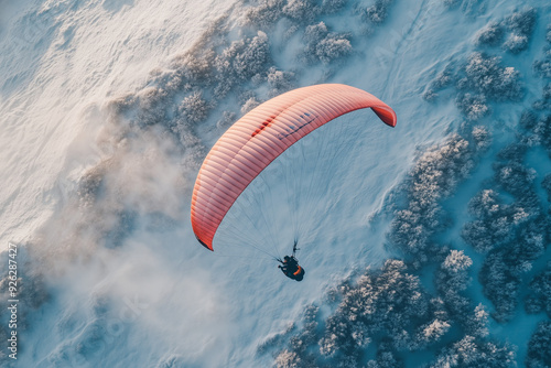Paragliding on the snow forest with tiny bush, Aerial view paraglider with parachute on the top of snow mountain.