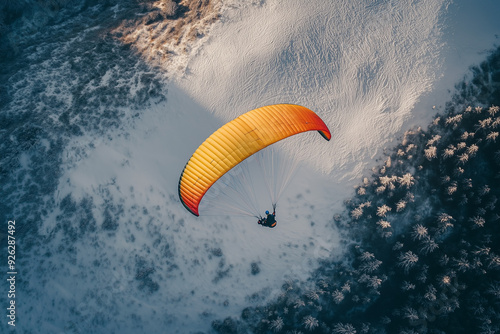 Paragliding on the snow forest with tiny bush, Aerial view paraglider with parachute on the top of snow mountain.