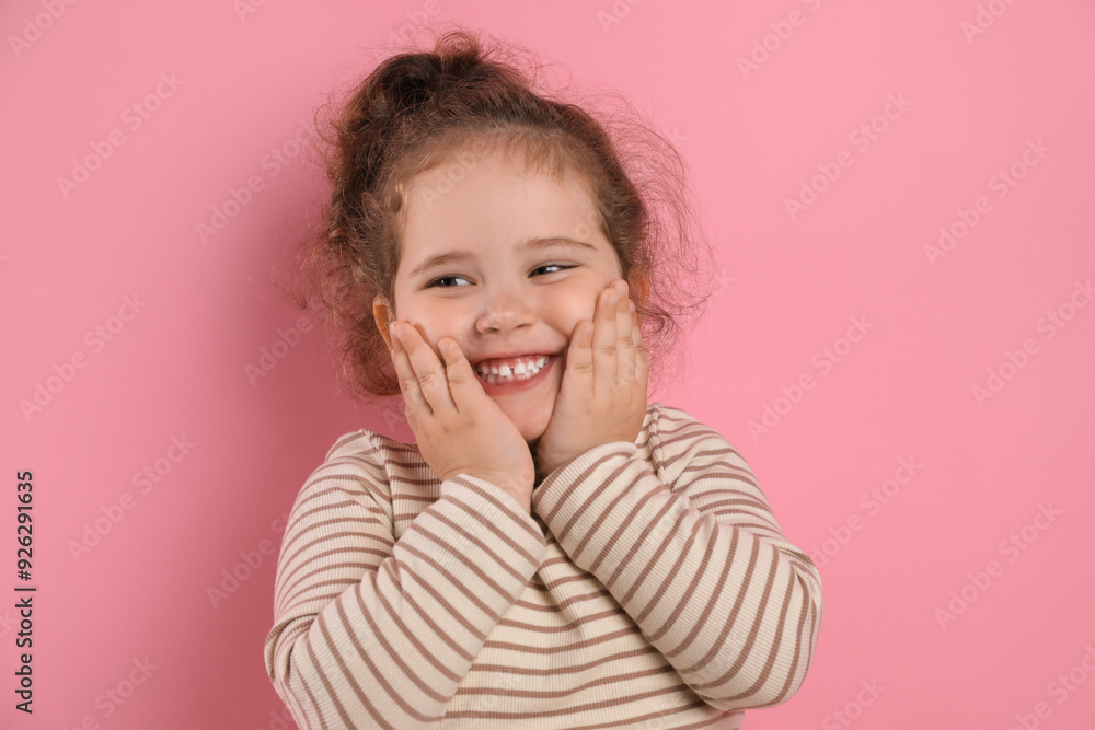 Adorable child. Portrait of happy girl on pink background Adorable child. Portrait of happy girl on pink background