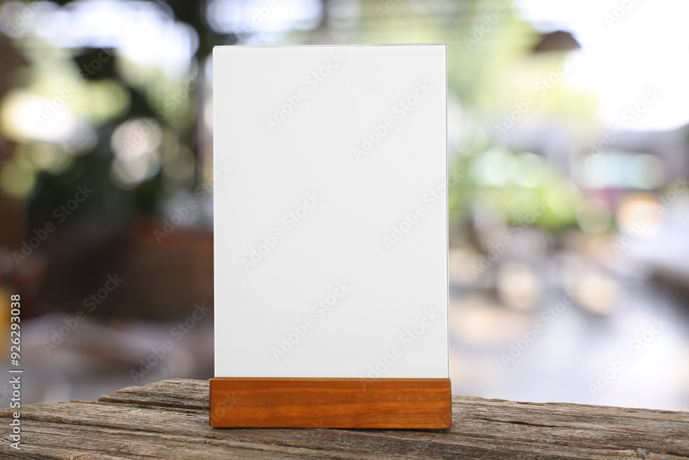 Menu holder with blank card on wooden table in cafe. Mockup for design Menu holder with blank card on wooden table in cafe. Mockup for design
