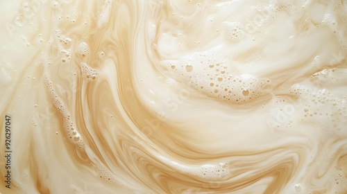 An artistic swirl of creamy mixture, showcasing rich textures and warm hues for culinary or abstract design projects.
