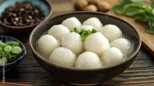 Delicious Tangyuan - Red and White Glutinous Rice Dumplings in Savory Soup Bowl on White Background