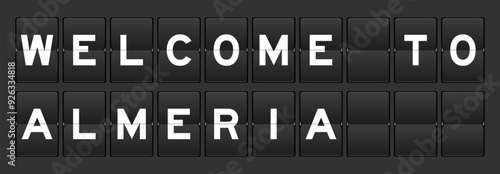 Black color analog flip board with word welcome to almeria on gray background