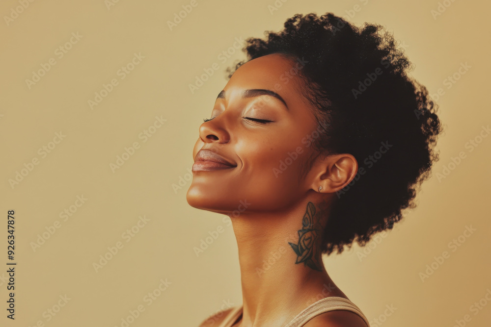 A close up of a tattooed black woman's face with her eyes closed A close up of a tattooed black woman's face with her eyes closed