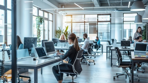 Modern Open-Plan Office with Employees Working at Desks
