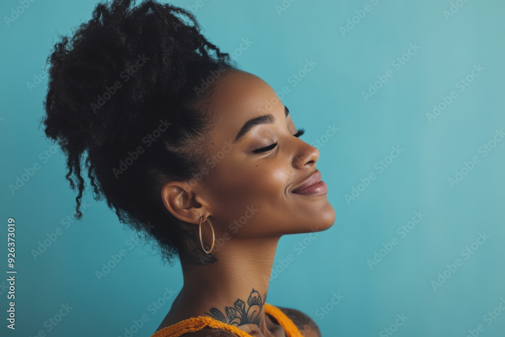 A close up of a tattooed black woman's face with her eyes closed A close up of a tattooed black woman's face with her eyes closed