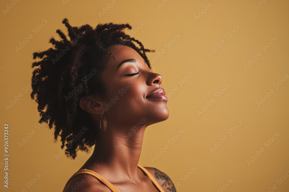 A close up of a tattooed black woman's face with her eyes closed A close up of a tattooed black woman's face with her eyes closed