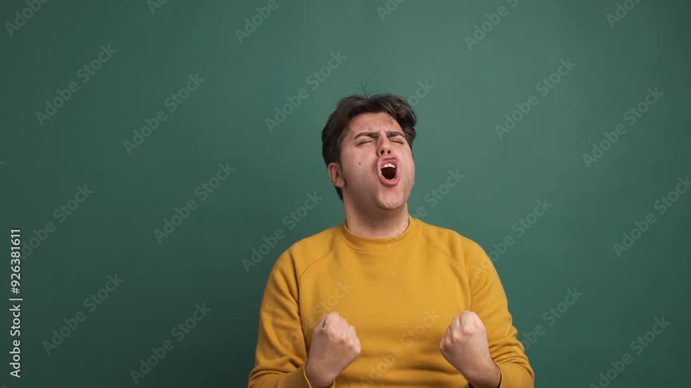Successful man shouting joyfully in green studio Successful man shouting joyfully in green studio