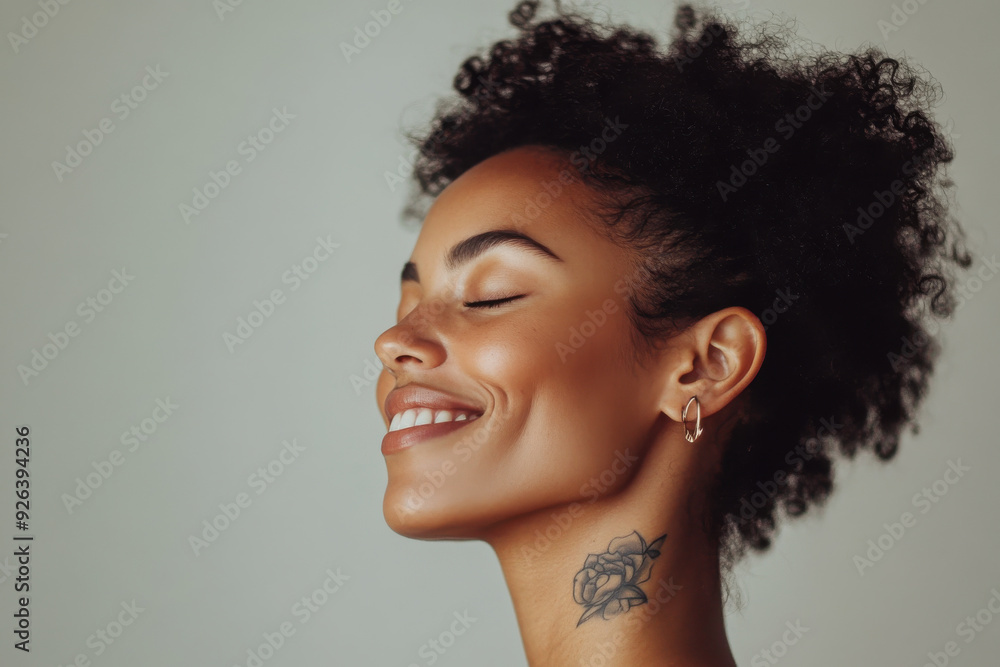 A close up of a tattooed black woman's face with her eyes closed A close up of a tattooed black woman's face with her eyes closed