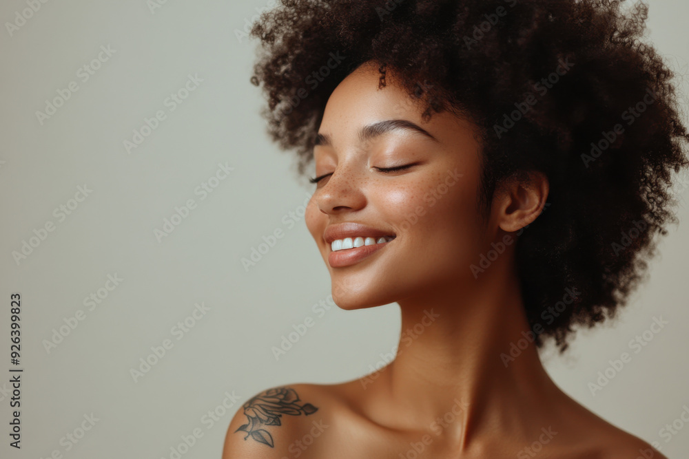 A close up of a tattooed black woman's face with her eyes closed A close up of a tattooed black woman's face with her eyes closed