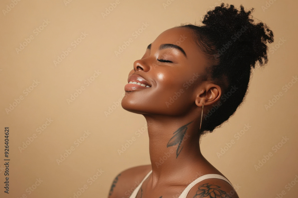 A close up of a tattooed black woman's face with her eyes closed A close up of a tattooed black woman's face with her eyes closed