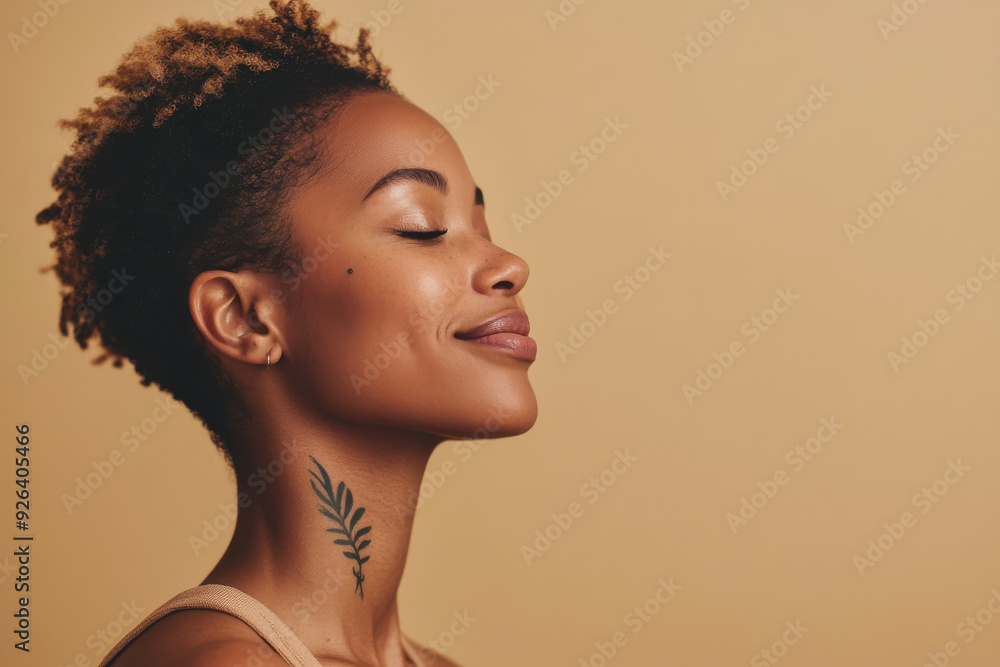 A close up of a tattooed black woman's face with her eyes closed A close up of a tattooed black woman's face with her eyes closed