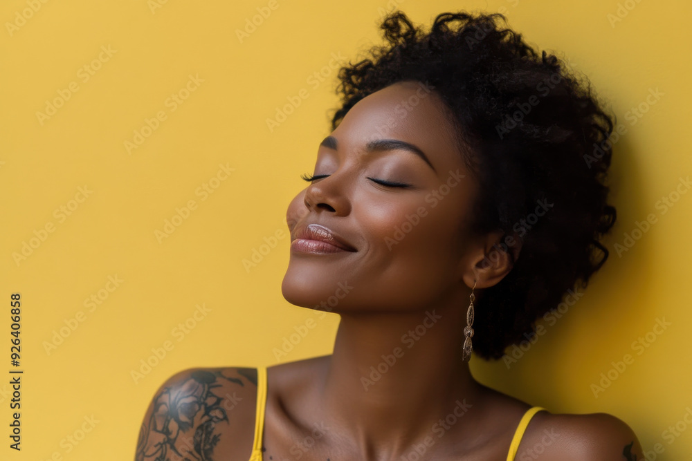 A close up of a tattooed black woman's face with her eyes closed A close up of a tattooed black woman's face with her eyes closed