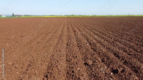Colors of the countryside with yellow rapeseed, plowed land and green wheat fields seen from the drone. Between San Giuliano Vecchio and Valmadonna, Alessandria, Piedmont, Italy