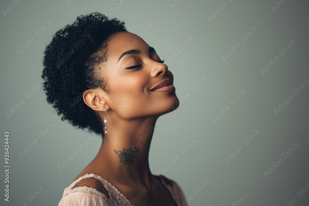 A close up of a tattooed black woman's face with her eyes closed A close up of a tattooed black woman's face with her eyes closed