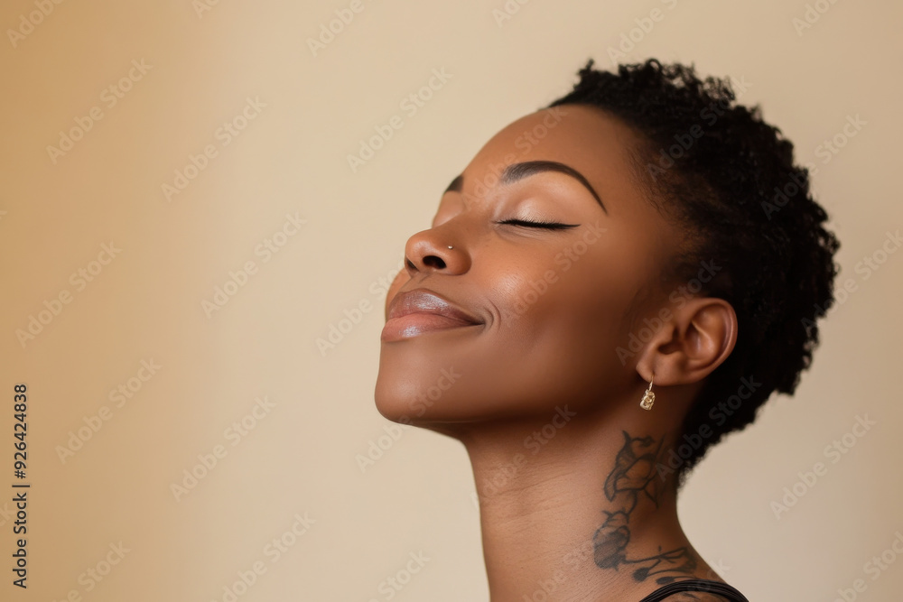 A close up of a tattooed black woman's face with her eyes closed A close up of a tattooed black woman's face with her eyes closed