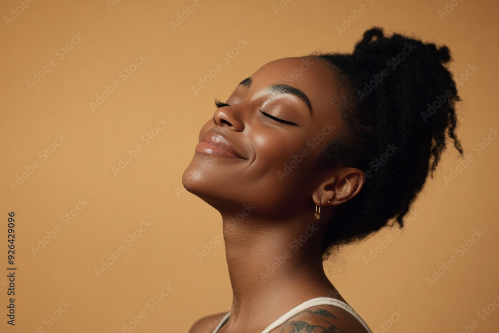 A close up of a tattooed black woman's face with her eyes closed A close up of a tattooed black woman's face with her eyes closed