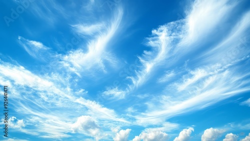 Vibrant azure sky filled with billowing cumulus clouds. Brilliant sunlight streaming through, creating a heavenly atmosphere. Perfect backdrop for concepts of hope, freedom, and endless possibilities.