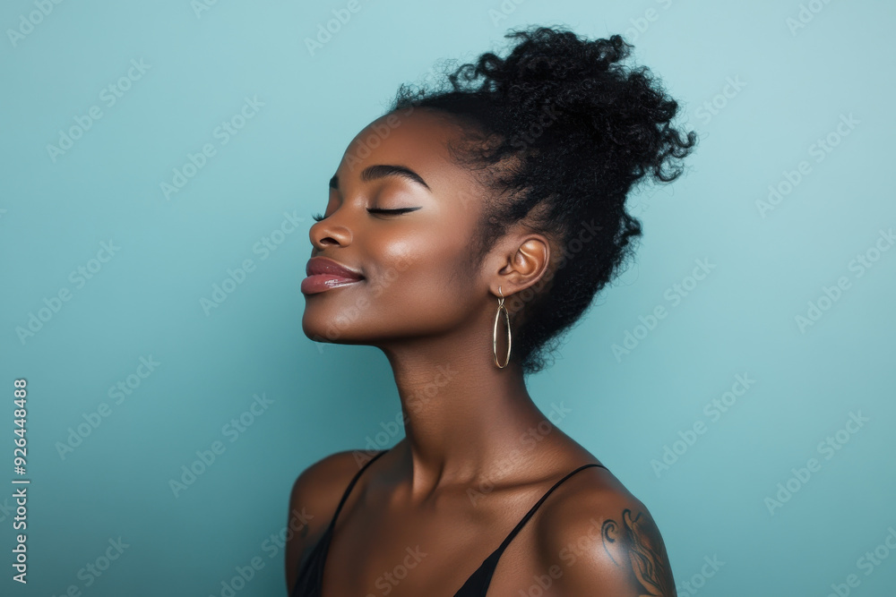 A close up of a tattooed black woman's face with her eyes closed A close up of a tattooed black woman's face with her eyes closed