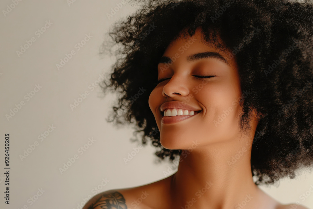 A close up of a tattooed black woman's face with her eyes closed A close up of a tattooed black woman's face with her eyes closed