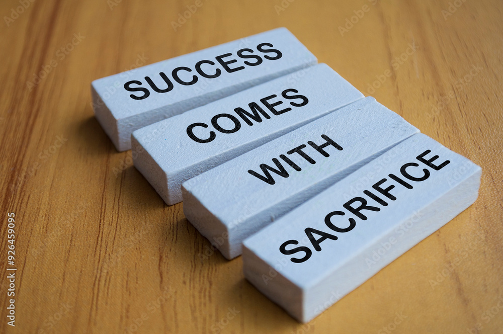 Angel view of Success Comes With Sacrifice text on white wooden blocks. Motivational and inspiration concept Angel view of Success Comes With Sacrifice text on white wooden blocks. Motivational and inspiration concept