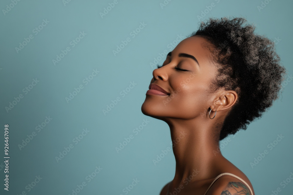 A close up of a tattooed black woman's face with her eyes closed A close up of a tattooed black woman's face with her eyes closed